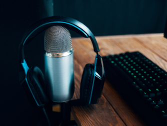 Micrófono con auriculares sobre mesa listo para grabar un podcast
