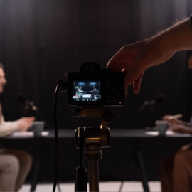 Cámara grabando una entrevista durante la producción de un podcast.
